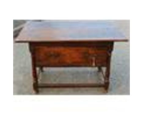 An early 18th Century oak joined centre table, converted to a side table, with the addition of a later drawer, raised on turn