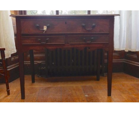 A George III mahogany side table, circa 1770, fitted with a long single drawer over two short drawers, raised on square taper