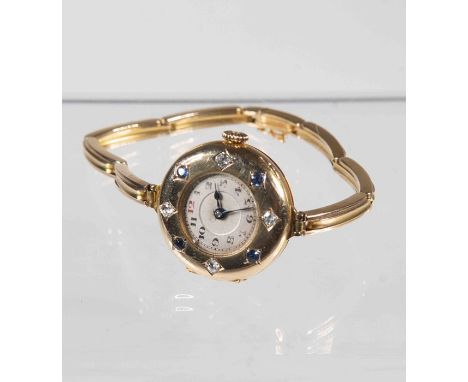 A lady's 14ct gold wristwatch, 15 jewel manual movement, having circular dial, Arabic numerals, bezel set alternately with sa