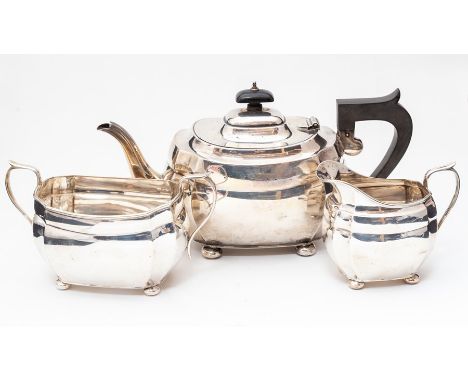 A George V silver three piece tea service comprising teapot, sugar bowl and milk jug, of plain&nbsp;bombe form with fluted se