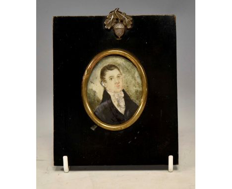 A George III oval portrait miniature of a gentleman, circa 1820, wearing a white stock with jewel attached and a black tunic,