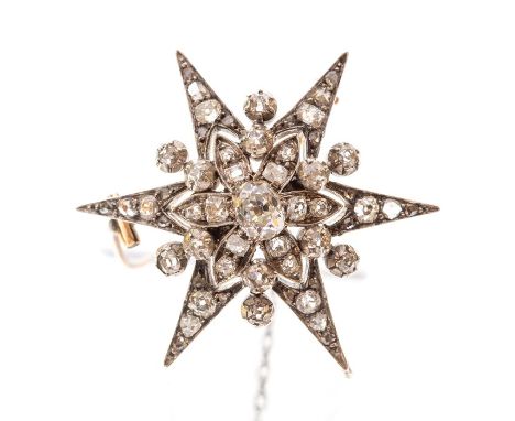 A Victorian diamond set star brooch, central oval old cut and round/cushion shaped diamonds to surround, a total diamond weig