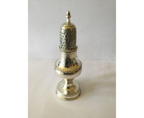 A George III silver baluster caster, the top engraved with diagonals and pierced within beneath urn shaped finial, Hester Bat