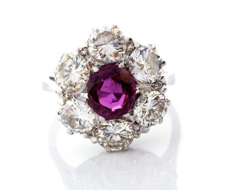 A ruby and diamond cluster ring, the central ruby weighing approx.1.05 carat, with a border of six round brilliant cut diamon