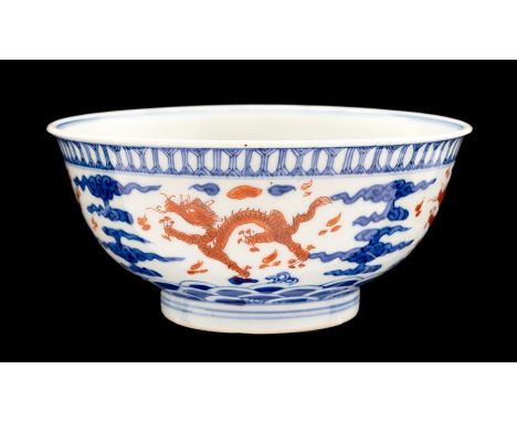 A Chinese bowl, possibly Kangxi mark and period, the interior and frieze decorated with dragons in iron red chasing flaming p