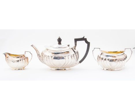 A George V matched three piece silver tea service comprising teapot, sugar bowl and milk jug,&nbsp; of ovoid form with curved