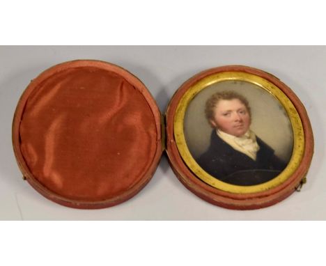 A George III oval portrait miniature of a young gentleman, circa 1820, wearing a white stock and blue tunic, on ivory, in a h