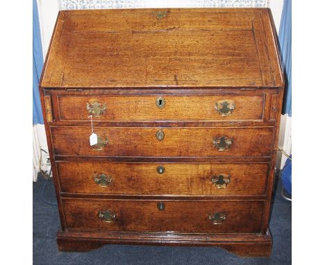 A George III oak bureau, fall front enclosing fitted interior, fitted with four long graduated drawers, bracket feet