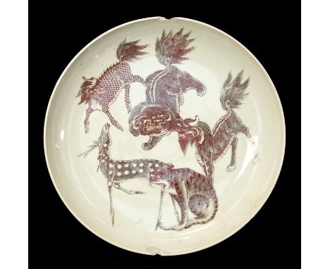 A Chinese Yongzheng or early Qianlong style dish, 19th Century or earlier, decorated with beasts and a deer in grey and iron 