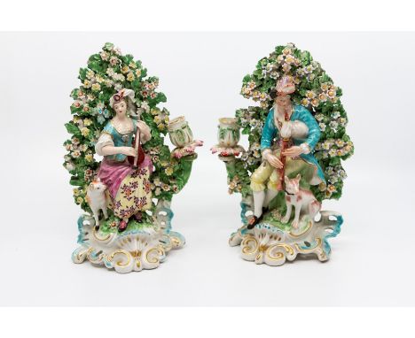 A pair of Derby patch mark figural candlesticks, circa 1760-65, modelled as shepherd and shepherdess musicians before boccage