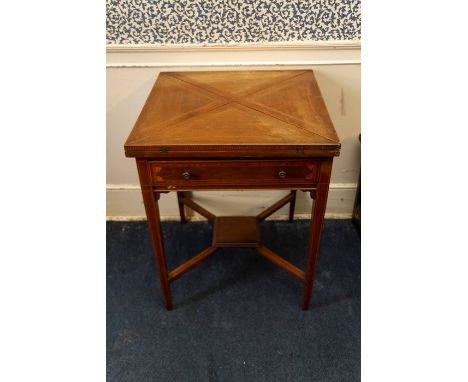 An Edwardian mahogany envelope card table, the top&nbsp;swivelling round to reveal well and opening out to&nbsp;reveal a cent