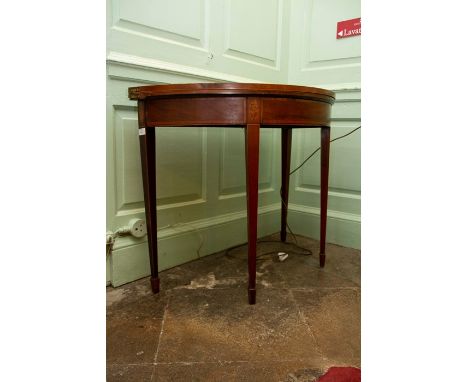 A George III mahogany and inlaid card table, of&nbsp;demilune form, raised on square tapered legs