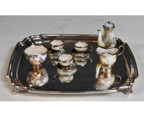 A late 19th Century&nbsp;enamel white metal mounted miniature tea service probably Austrian comprising three cups and saucers