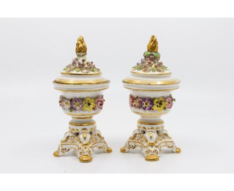 A pair of Derby King Street florally encrusted potpourri vases and covers, each on four lions paw feet, puce marks, 15cm high