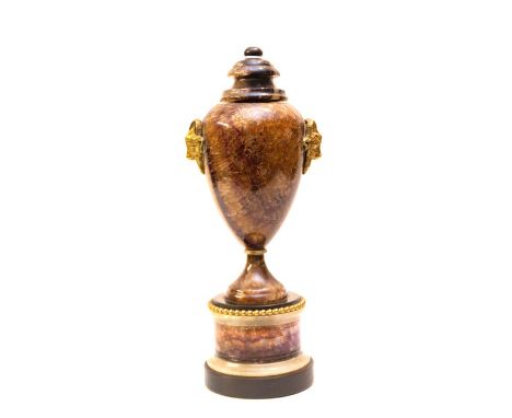 A 19th Century Derbyshire Blue John covered urn in the manner of Matthew Boulton, circular turned finial, baluster body with 