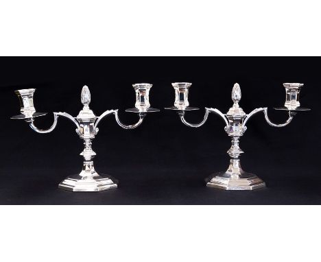 A pair of George I style silver candelabras, octagonal facet shaped with central foliate finial, the sconces drip pans (not d