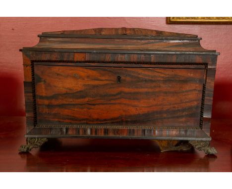 A mid 19thC tea caddy on lion claw feet.