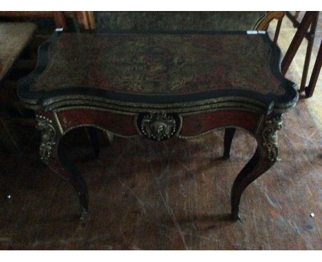 A mid 19thC French Boulle-work fold over card table inlaid with tortoise shell and brass, serpentine fronted, raised on Frenc