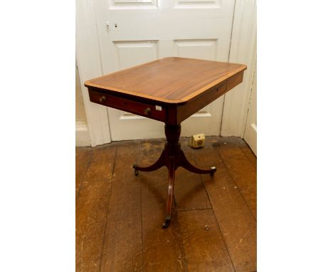 A Regency mahogany occasional table, crossbanded and inlaid with stringing, the rectangular top with a drawer to each end, a 