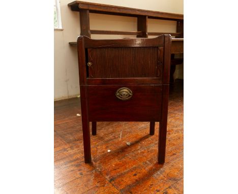 A George III mahogany bedside commode, circa 1770, tray top, tambour door below over a retractable base, height 75cmProvenanc