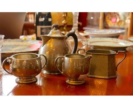 A Tudric hammered pewter coffee pot with Tudric milk and sugar bowls, plus one additional bowl (English petwer) (4)