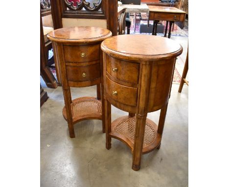 A pair of John Lewis walnut circular bedside tables/lamp tables each with two drawers and carved undertier, 40 cm diam x 74 c