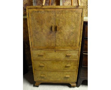A vintage burr walnut cabinet on three drawer chest, on shaped bracket feet
