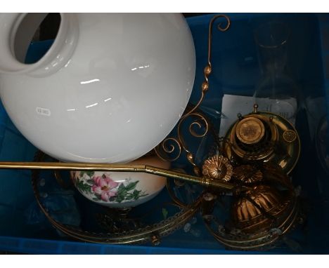 A brass ceiling oil lamp with opaque glass shade and lustre drops