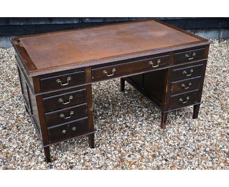 A large vintage mahogany pedestal desk with inset leatherette top over an arrangement of nine drawers, 153 x 91 x 78 cm high