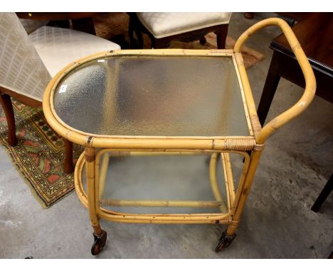 A vintage bamboo and glass two-tier trolley