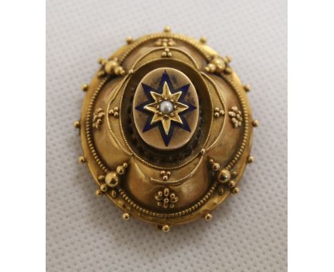 Victorian gilt metal brooch with seed pearl set in blue enamel star motif and locket back containing a photograph.