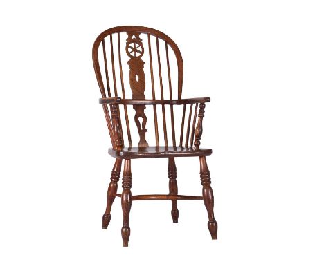 A early-mid 19th century ash and elm Windsor armchairOf hoop-back form, the shaped splat with pierced wheel, the saddle seat 