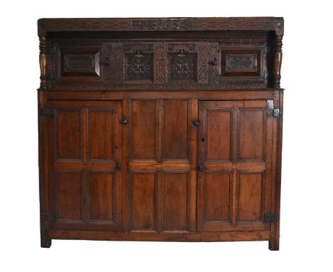 A 17th century oak court cupboardThe top rail carved with strapwork and a central monogram RMB and dated 1684 on turned balus