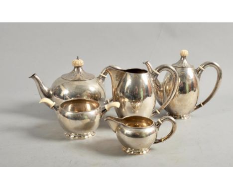 A 1920's Austrian five piece tea and coffee service of beaten baluster design with bone knops, handles and ferrules, makers a