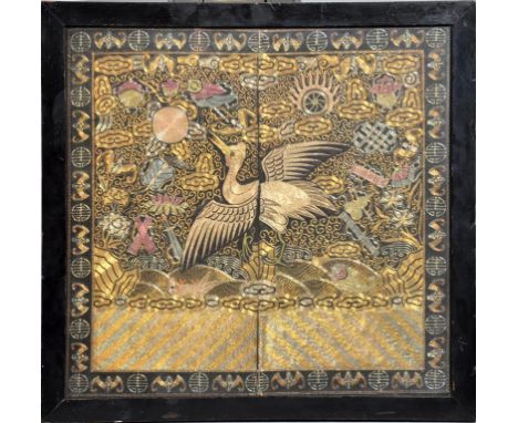 A Mandarin's coat panel circa 1830, worked in coloured metallic threads depicting a crane flying above the waves within cloud