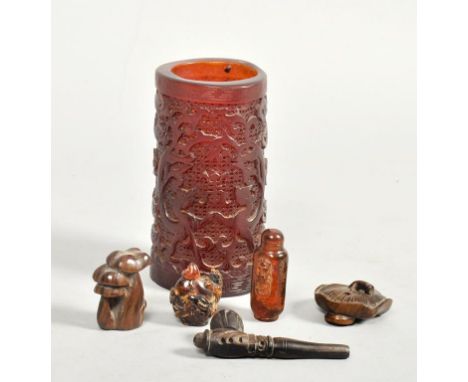 An Oriental amber resin brush pot together with two wood netsuke carved as mushrooms, a small pipe and two snuff bottles.