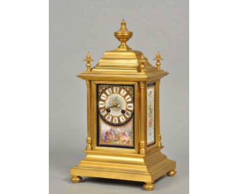 A late 19c French mantel clock in rectangular stepped ormolu case, the top having four corner finials and a central urn and t