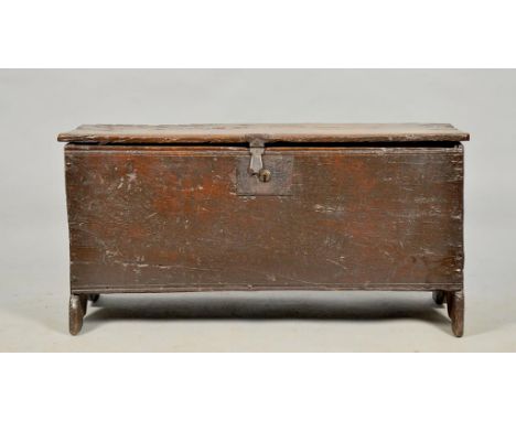 An early 17c oak five panel coffer with simple chip carving to vertical front edges, wire hinges replaced and with old iron p