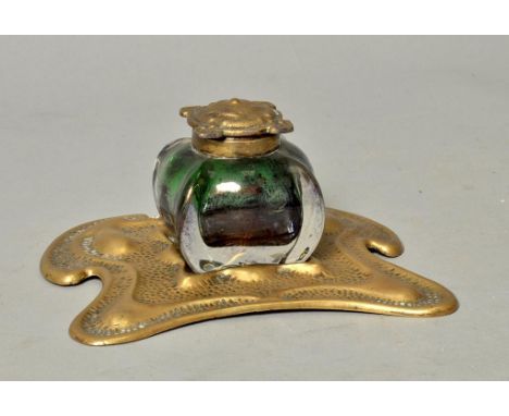 An Art Nouveau brass single bottle inkstand with a moulded green glass inkwell, 6.5h, 3h.