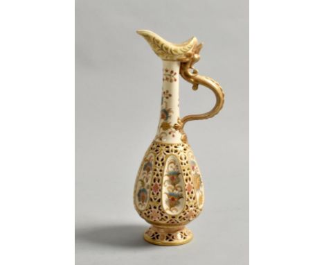A Zsolnay Pecs ewer of octagonal form with reticulated body and floral painted panels, the ewer with gilt dragon handle and b