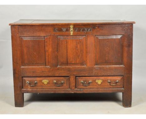 An early 18c oak three panel mule chest bearing monogram 'CW' and date '1737', having two short drawers and stile legs, 49w, 
