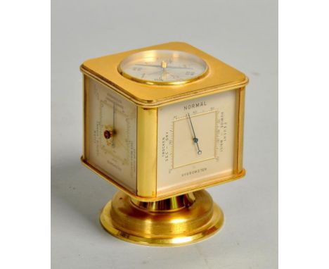 A mid 20c Swiss desk clock by Augustus in the form of a rotating cube on a circular stand.  The faces of the cube contain a c