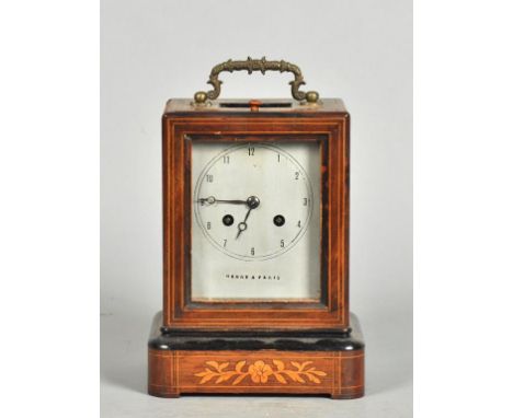 A mid 19c French mantel clock in rectangular rosewood case with boxwood inlay and ebonised mouldings.  The case has a top gla