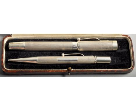 A silver fountain pen and propelling pencil set, both barrels engine turned and with open rectangular cartouche, makers mark 