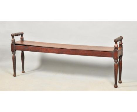 An early 19c mahogany bench seat supported on baluster turned legs and with raised bobbin turned roll ends, 59w, 24h.