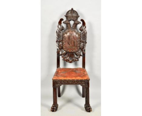 A late 18c/early 19c oak and walnut side chair, the profusely carved back panel formed by two opposing winged eagles under a 