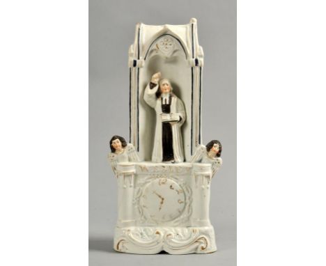 A 19c white glazed clock figure group of John Wesley preaching and flanked by two angels, a/f, 11h.