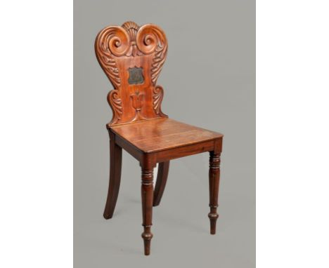 An early 19c mahogany side chair with scroll and leaf carved back panel, having a central shield monogram 'B', with solid sea