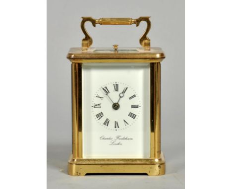 A 20c carriage clock, the white rectangular dial signed Charles Frodsham, London and having Roman numerals and moon hands.  T