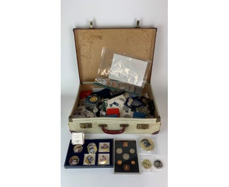 A vintage case of mixed coins and medals.